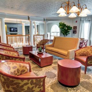 A cozy and elegant living room featuring comfortable seating, stylish furniture, and warm lighting.
