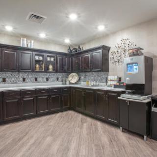 A stylish modern kitchen featuring dark cabinets, ample counter space, and contemporary appliances.