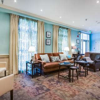 A cozy and elegantly decorated living room with comfortable seating and warm lighting.