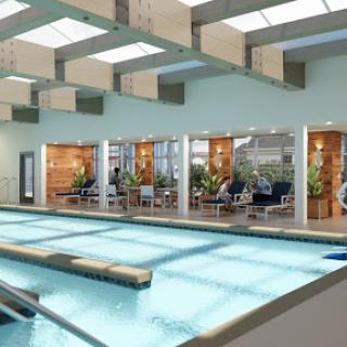 A serene indoor pool area featuring modern design and ample natural light.