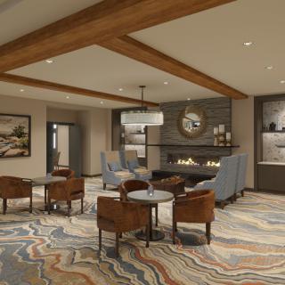 A modern lobby with a cozy seating area featuring a fireplace and contemporary decor.