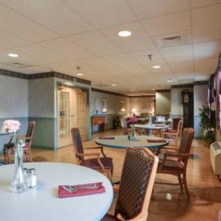 An empty dining room with neatly arranged tables and chairs.
