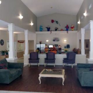 A spacious living room with comfortable seating and a high vaulted ceiling.