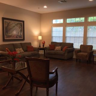 A cozy living room with comfortable seating and warm lighting.