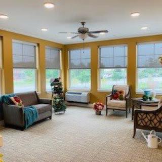Bright and cozy living room with large windows and comfortable seating.