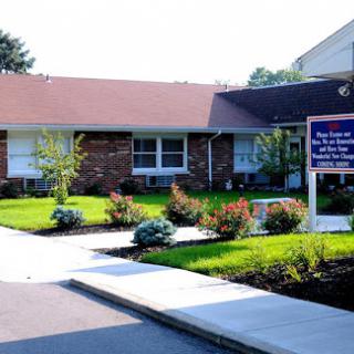 A healthcare facility with a welcoming entrance and well-maintained landscaping.