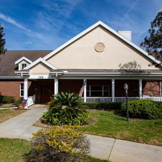 A residential building with a well-maintained garden and pathway.