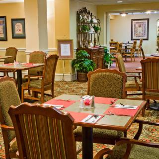 A cozy restaurant dining area with neatly arranged tables and upholstered chairs.