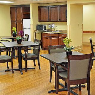 A cozy kitchen and dining area with wooden furniture and modern appliances.