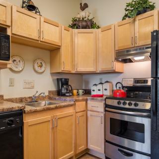 A cozy kitchen with wooden cabinets and stainless steel appliances.