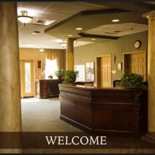 A welcoming reception area with a central desk and warm lighting.