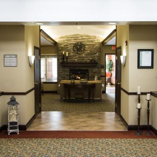 A cozy lobby area featuring a stone fireplace and warm decor.