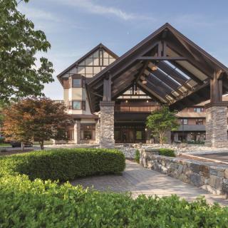 A modern building with an impressive entrance and well-maintained landscaping.