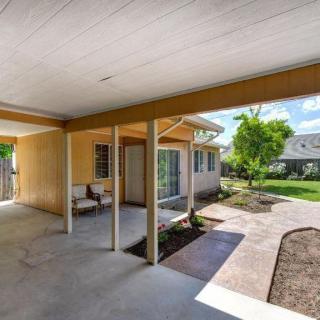 A spacious backyard with a covered patio area, perfect for outdoor relaxation.