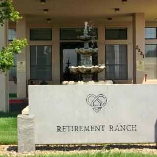 Entrance to a retirement ranch with a decorative fountain.