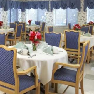 A neatly arranged dining area with tables set for a meal.