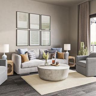 A modern living room with neutral tones, featuring comfortable sofas and a round coffee table.