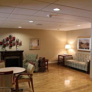 A cozy lounge area featuring comfortable seating, warm lighting, and decorative elements, designed for relaxation and social interaction.