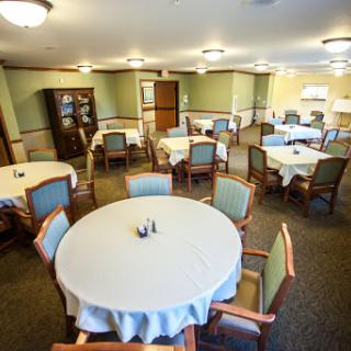 A spacious dining area with round tables set for meals.