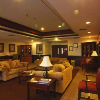 A cozy lobby area with comfortable sofas and warm lighting.