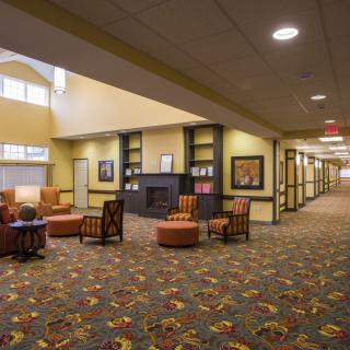 A spacious lobby with comfortable seating and warm lighting.
