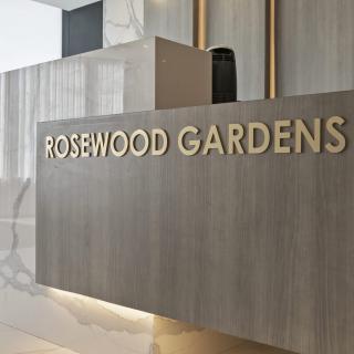 Modern reception area with Rosewood Gardens signage.