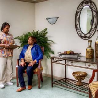 A nurse interacting with a patient in a healthcare waiting room.