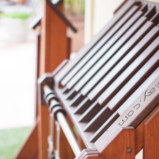A stack of wooden chairs neatly arranged outdoors.