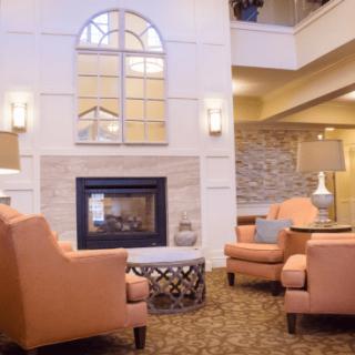 A cozy lobby with comfortable armchairs and a fireplace, offering a warm and inviting atmosphere.