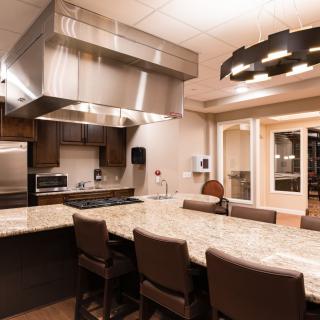 A modern kitchen with stainless steel appliances and a large island counter.