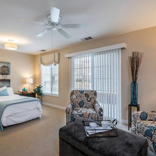 A cozy and well-lit bedroom featuring stylish furniture and a relaxing atmosphere.