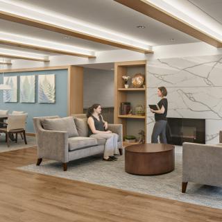 A modern lobby with comfortable seating and a fireplace.