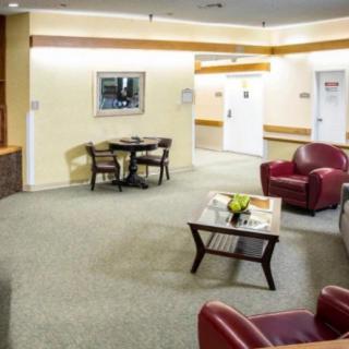 A modern lobby with seating and a coffee table.