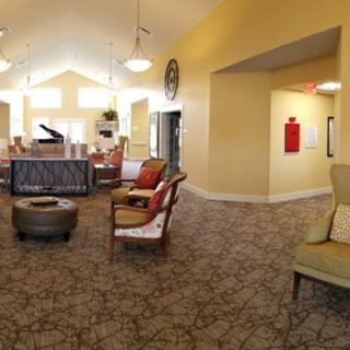 A cozy lounge area with comfortable seating and a grand piano.