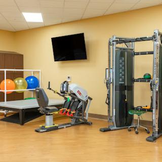 A well-equipped gym area featuring various fitness machines and exercise accessories.
