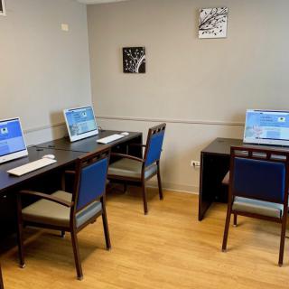 A small computer lab with workstations and chairs arranged neatly.