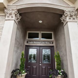 Elegant entrance with double doors and decorative columns.
