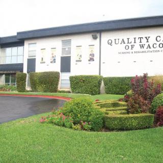 A view of Quality College of Waco with manicured lawns and shrubs.