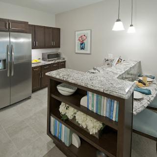 A sleek and modern kitchen featuring stylish appliances and a cozy dining nook.