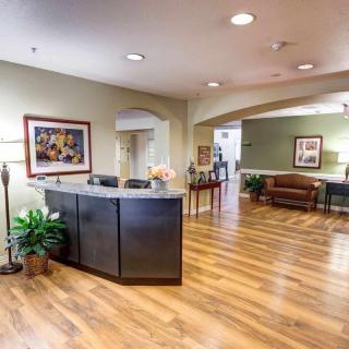 A modern reception area with wooden flooring and a welcoming desk.