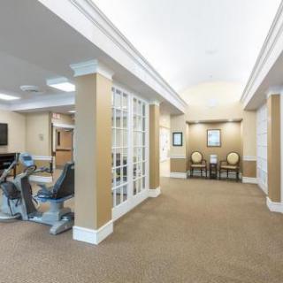 A spacious and well-lit gym area featuring exercise equipment, designed for community recreation.
