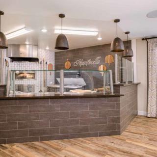 A modern cafe interior with a sleek counter and stylish lighting.