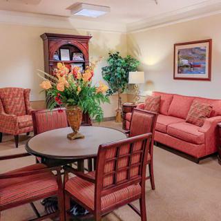 A cozy living room with comfortable seating, decorative flowers, and a welcoming ambiance.