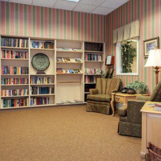 A cozy library corner with bookshelves and armchairs.