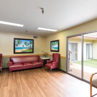 A bright and inviting waiting area featuring comfortable seating and landscape artwork.