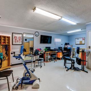 A well-equipped physical therapy room featuring various exercise machines and equipment.