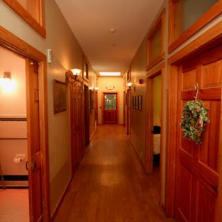 A warm and inviting hallway featuring wooden doors and soft lighting.