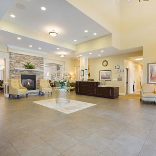 A spacious and elegantly decorated lobby with a fireplace and comfortable seating areas.
