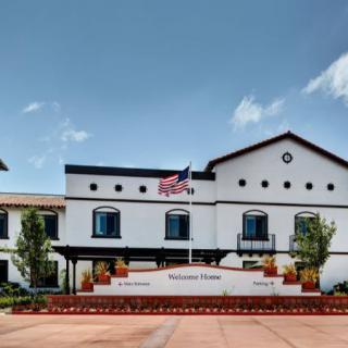 A modern building with an American flag on a clear day.
