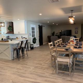 A modern open-concept living space with a kitchen, dining area, and living room.
